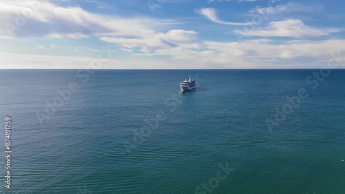 Aerial view of the big cruise ship floating in the open water of the Atlantic Ocean during summer vacations 