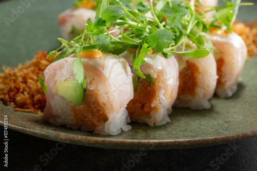 A closeup view of a sushi roll, featuring spicy albacore and yellowtail. photo