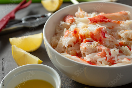 A view of a bowl full of king crab leg meat. photo