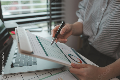 businesswoman working on laptop in her studio, businessperson working on a digital tablet and laptop in an office, busy professional executive leader working on business finances analysis