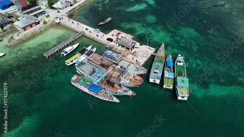 Passengers disembarking from a wooden boat at the harbor. Aerial view