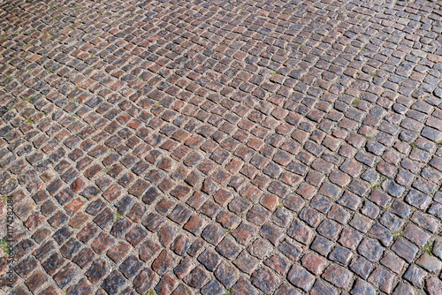 Stone road pattern background. Cobblestone pavement background. Textured background of cobblestone road. Brick road background.