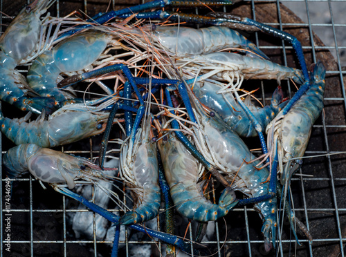 River prawns on a grill. Popular seafood dishes: Grilled prawns. Fresh prawns, grilled or roasted over a fire.