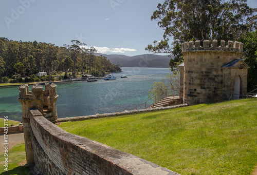 Port Arthur historical site in Tasmania, Australia, with stone tower, scenic waterfront, and lush green surroundings photo