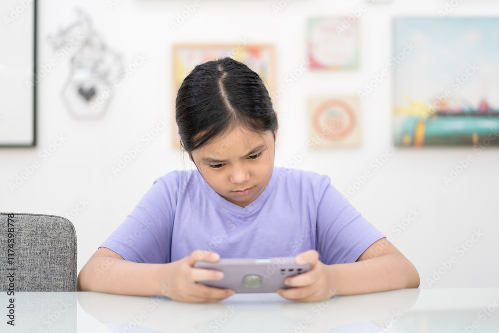 asian child playing game on smartphone or kid girl holding looking mobile phone and stressed angry or frown bad mood to addicted hyperactive or people watching phone and technology learning on white asian child playing game on smartphone or kid girl holding looking mobile phone and stressed angry or frown bad mood to addicted hyperactive or people watching phone and technology learning on white
