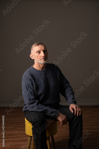 Authentic studio portrait of a handsome older man, selective focus