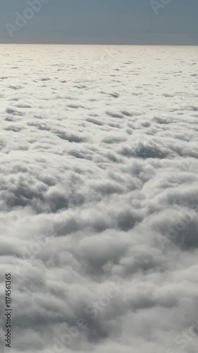 The sky is filled with clouds, creating a sense of calm and serenity. The clouds are white and fluffy, giving the impression of a peaceful, cloudy day