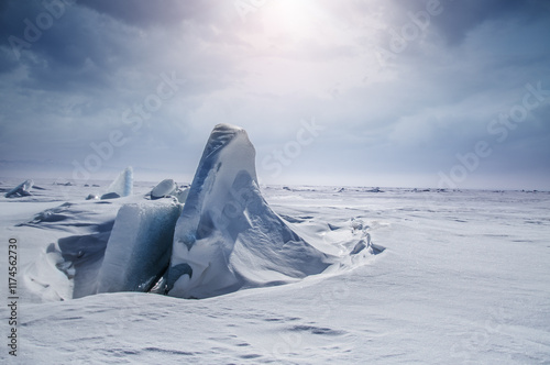 Ice rock on frozen lake