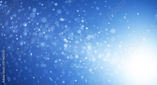 Dreamy blue bokeh with scattered glowing light circles