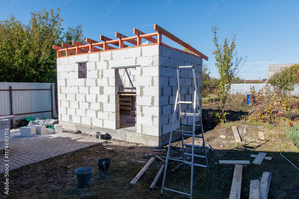 A construction site with a ladder leaning against a wall A construction site with a ladder leaning against a wall
