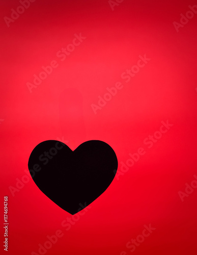 Black heart with red background.
