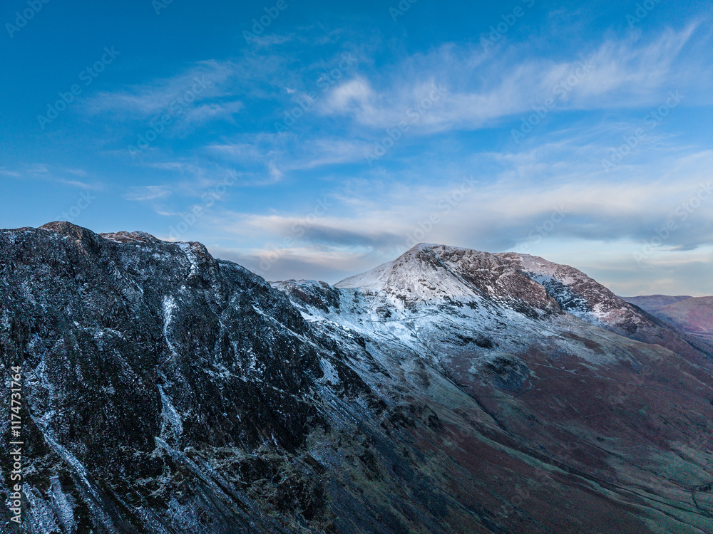 Dramatic aerial drone landscape in Autumn Winter of snowcapped mountains around Buttermere in Lake District at sunrise Dramatic aerial drone landscape in Autumn Winter of snowcapped mountains around Buttermere in Lake District at sunrise