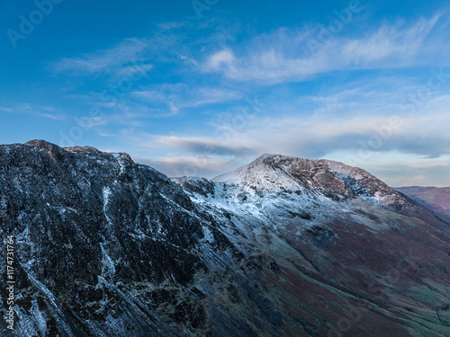 Dramatic aerial drone landscape in Autumn Winter of snowcapped mountains around Buttermere in Lake District at sunrise photo