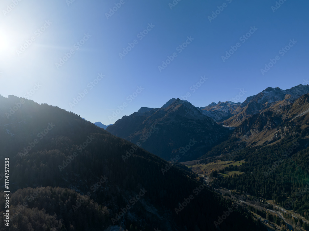Fototapeta premium Aerial view of alpine landscape at Swiss Maloja mountain pass on a sunny autumn day. Photo taken November 15th, 2024, Maloja Bregaglia, Switzerland.