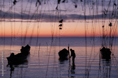 Winter morning on the Razim saltwater lake in the traditional fishing village of Sarichioi, one of the largest lakes in Romania, part of the Danube Delta Biosphere Reserve, Tulcea County, Romania photo