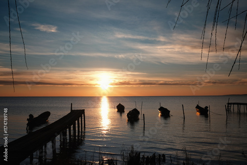 Winter morning on the Razim saltwater lake in the traditional fishing village of Sarichioi, one of the largest lakes in Romania, part of the Danube Delta Biosphere Reserve, Tulcea County, Romania photo