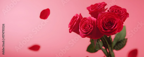 Valentine's day. A bouquet of vibrant red roses against a soft pink background, with scattered petals, evoking romance and beauty.
