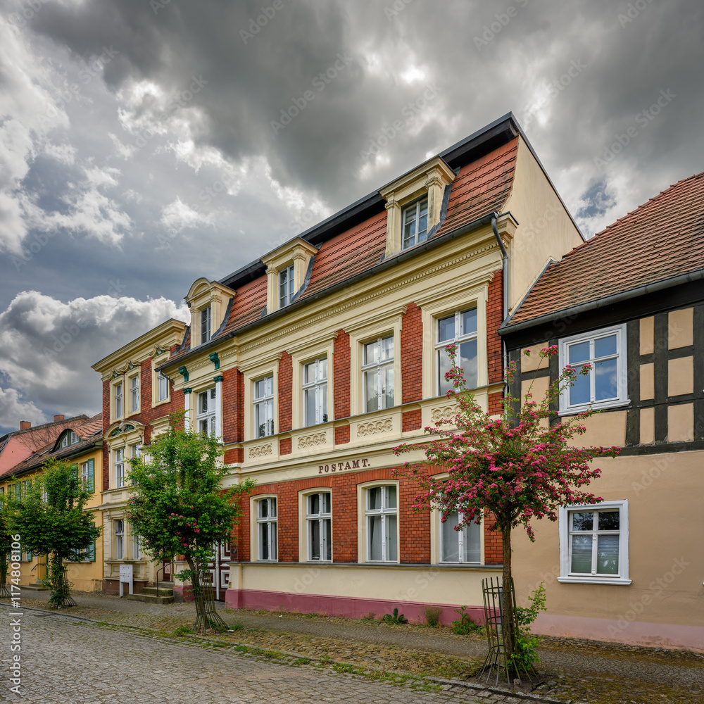 Fototapeta premium Denkmalgeschütztes historisches Postamtsgebäude am Kirchplatz in Neustadt (Dosse) - Inschrift: Postamt