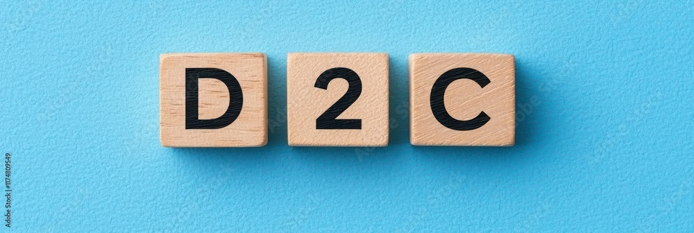 D2C Business Model Represented with Wooden Blocks on Vibrant Blue Background D2C Business Model Represented with Wooden Blocks on Vibrant Blue Background