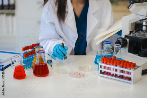 Female biotechnologist testing new chemical substances in a laboratory. photo