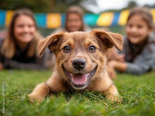 Smiling family spending quality time with an adopted dog in a colorful outdoor setting.