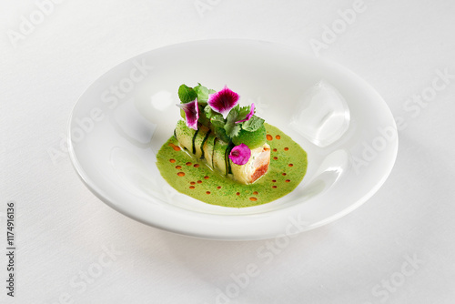 A gourmet dish featuring a delicate piece of fish, surrounded by a vibrant arrangement of fresh vegetables and edible flowers.