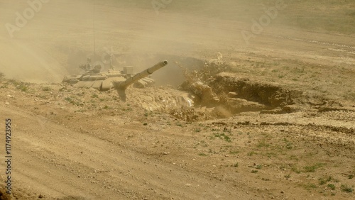 heavy tank crosses a ditch with mud and water