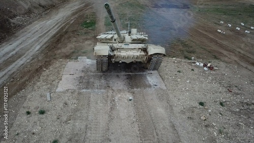 drone view - heavy tank climbs over walls