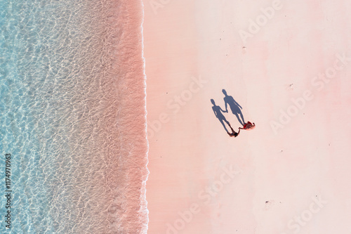 Aerial drone view of adult couple at pink sand beach, Komodo National Park, Indonesia photo