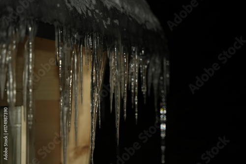 Icycles outside Kota Cabin in Lapland Finland on very cold icy winter night photo