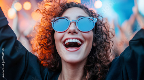 Joyful celebration at a lively outdoor music festival in the evening with a woman enjoying the atmosphere photo