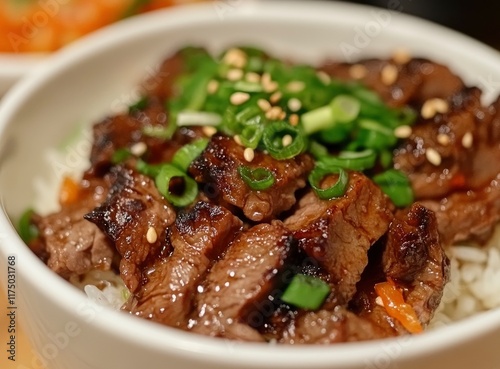 Bulgogi-style beef with rice, close-up shot of meat in a white bowl on a wooden table background. Close-up food photography. A Korean dish 
