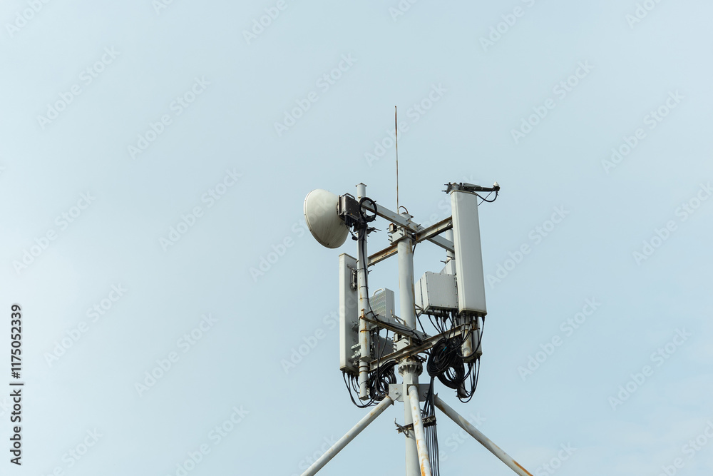 Telecommunication tower with antennas reaching for the clear sky in an urban area during daylight hours. Telecommunication tower with antennas reaching for the clear sky in an urban area during daylight hours.