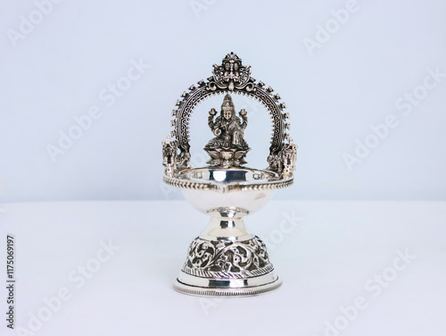 Sacred Silver Diyas with Indian God and Goddess Idols bring sacred blessings, prosperity, and spiritual charm to every home and celebration. Indian Pooja Diya. Pure 925 Silver Lamps used for praying photo