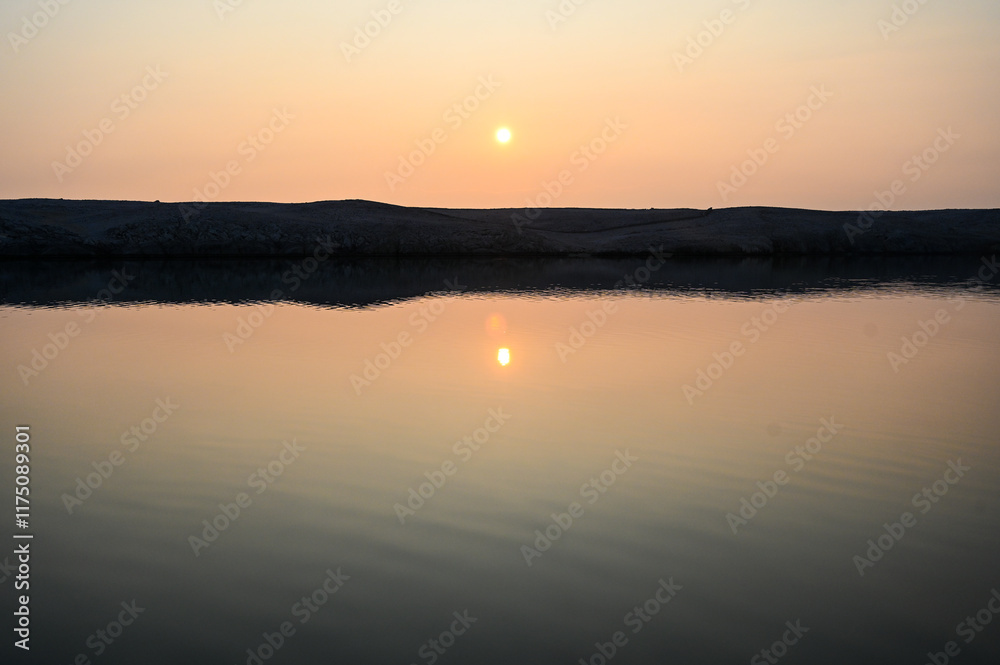 Naklejka premium Sunset on the sea. Reflection of the sun on the water.