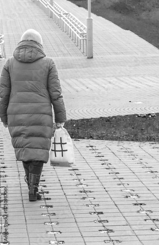 Woman with plastic bag and hash tag illustration on it walks outdoor. Concept
