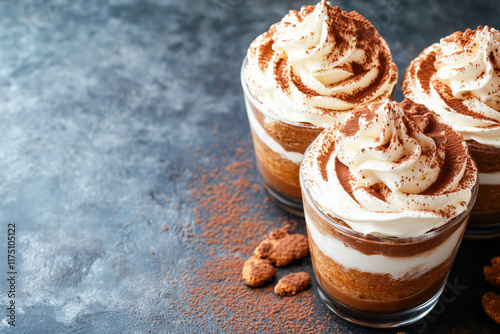 Delicious chocolate tiramisu dessert with whipped cream in glasses photo