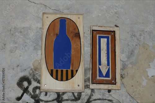 Blue bottle and arrow signs on the wall in Lviv, Ukraine photo