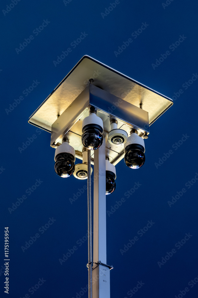 metal, pole, safety, monitoring, cityscape, technology, outdoor, surveillance equipment, control, watch, Four CCTV cameras mounted on a metal rig against a dark blue sky background metal, pole, safety, monitoring, cityscape, technology, outdoor, surveillance equipment, control, watch, Four CCTV cameras mounted on a metal rig against a dark blue sky background