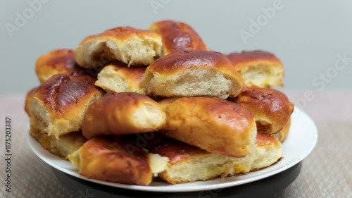 closeup on a pile of bread rolls on a shelf in a store cooking empanadas argetinian pie, traditional bakery from argentina, chef filling dough in home with meat, homemade spanish empanadas photo