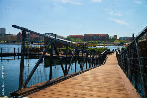 Wooden walkway with railings leading to stylish restaurant on city embank photo