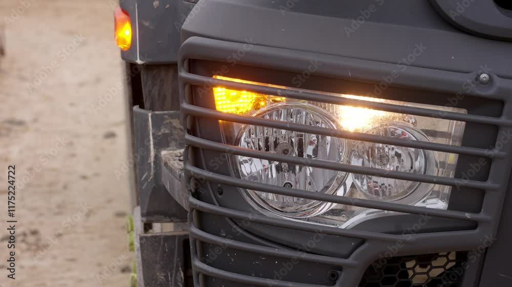 Close-up of Construction vehicle showcases bright flashing warning lights and safety features during daytime operations Close-up of Construction vehicle showcases bright flashing warning lights and safety features during daytime operations