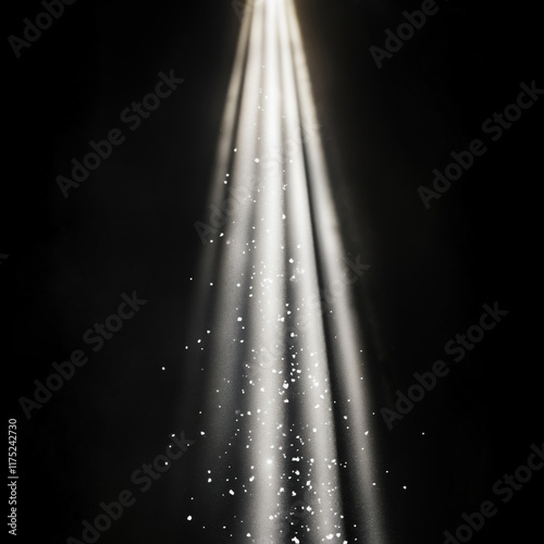 Vertical ray of light with bright snowy particles floating in it, isolated on black background