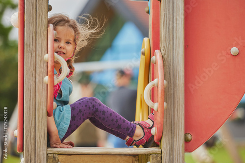 Charming child playing on a playground in Ringkobing Denmark