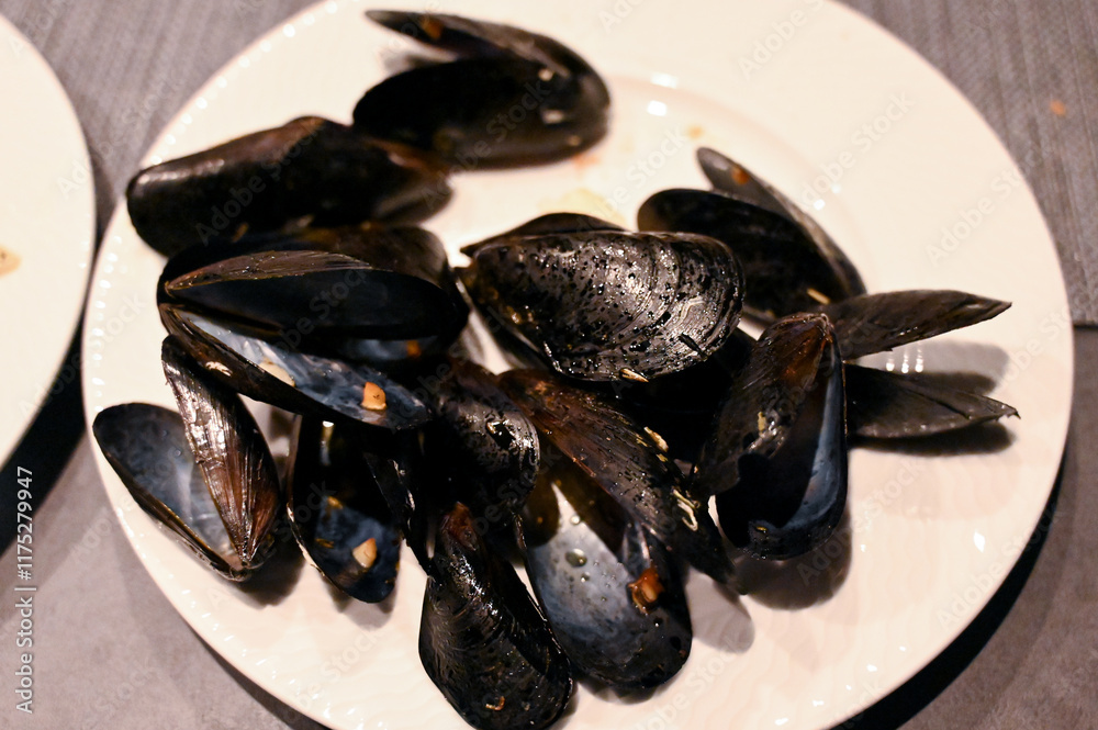 Stewed mussels served on a plate. Stewing shellfish. Stewed mussels served on a plate. Stewing shellfish.