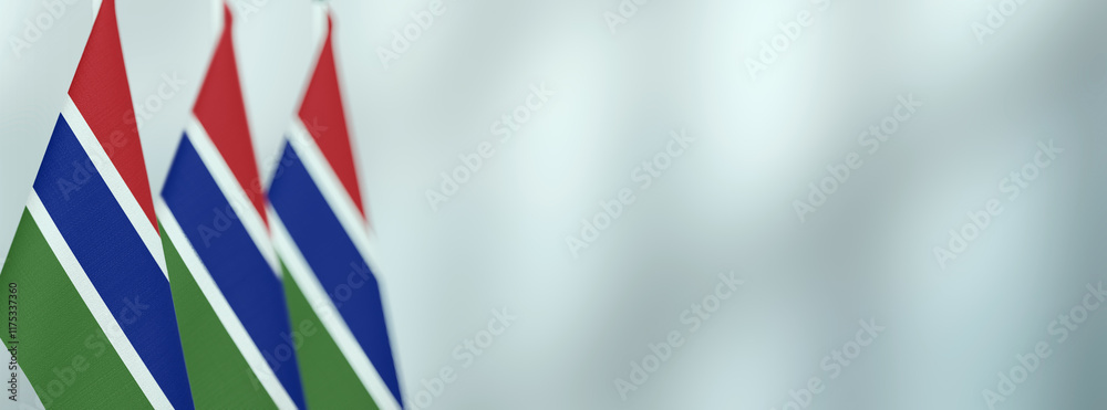 Gambia table flags in the office, banner background with space for text Gambia table flags in the office, banner background with space for text