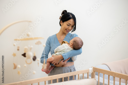 Obraz na płótnie Asian mother holding her baby at home w salonie