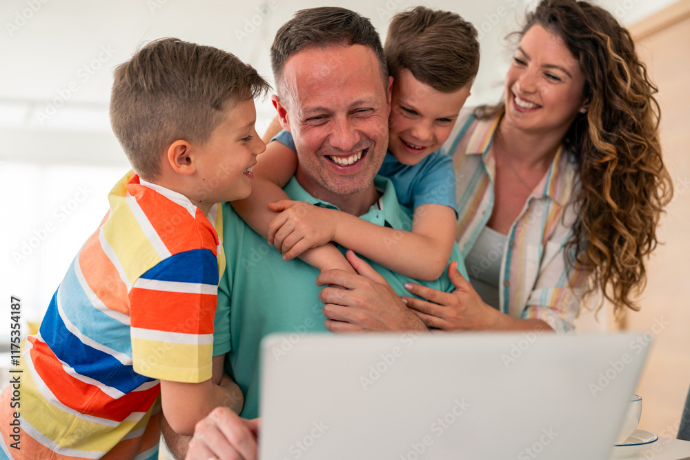 Caucasian professional father in casual attire works on laptop from home while family shares loving moment through playful interaction in bright interior setting. Caucasian professional father in casual attire works on laptop from home while family shares loving moment through playful interaction in bright interior setting.