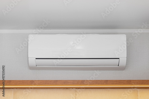 White Air Conditioner Mini Split Unit Mounted at Wall in Room