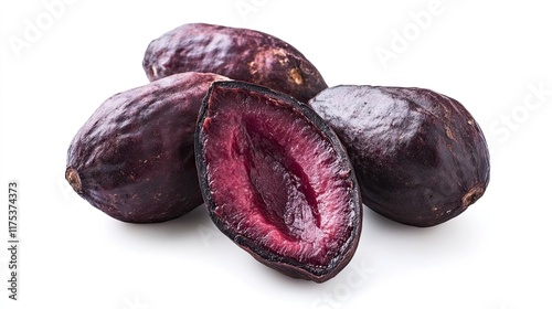 Close-up of halved and whole dark plums on white.  Food photography for recipe blogs or cookbooks. photo